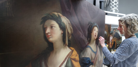 Painting conservator, working on Allegory of Painting and Music by Sirani, ahead of the opening of Renaissance Rediscovered at the Walker Art Gallery in July 2023 © Gareth Jones